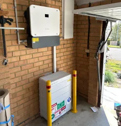 Solar inverter and floor-mounted battery setup for energy storage and backup