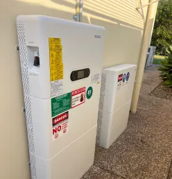 Solar battery installed on the exterior wall of a Queensland home for residential energy storage